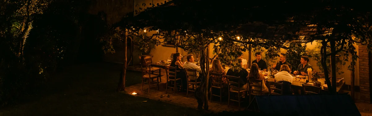 Family dinner under the pergola at night at Il Podere di Toscana Tuscany