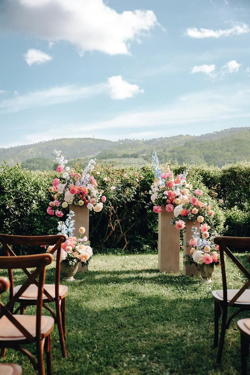 Couple walking among olive trees — intimate wedding Tuscany