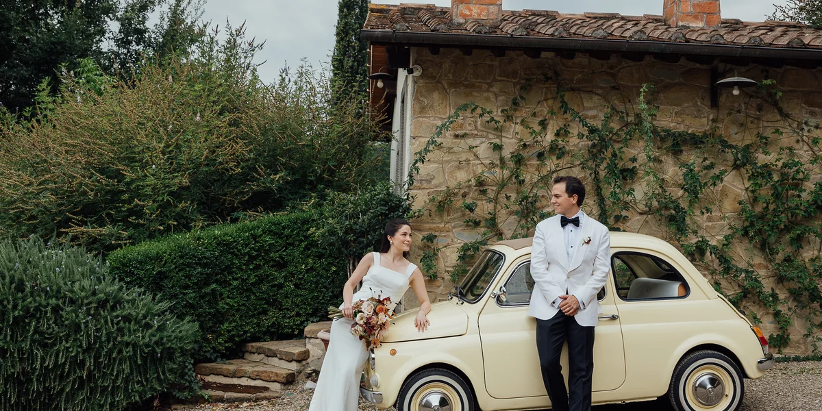 Bride and groom with vintage Fiat 500 at Il Podere di Toscana private villa Tuscany